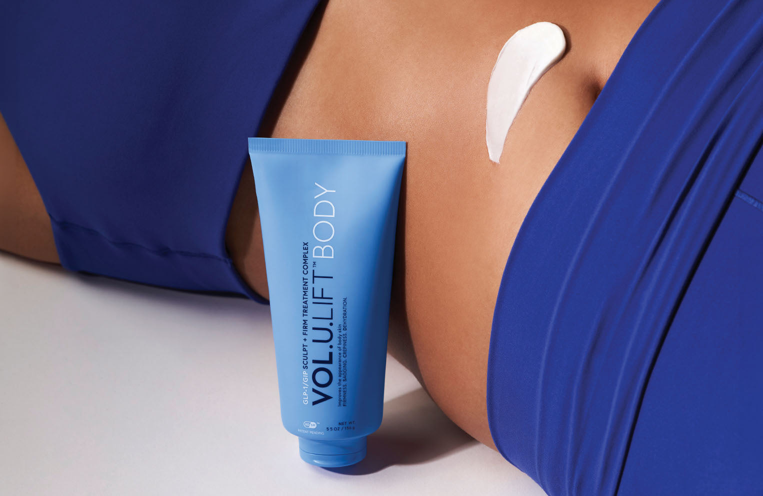 model stomach area with swatch of volulift body alongside tube of volulift body