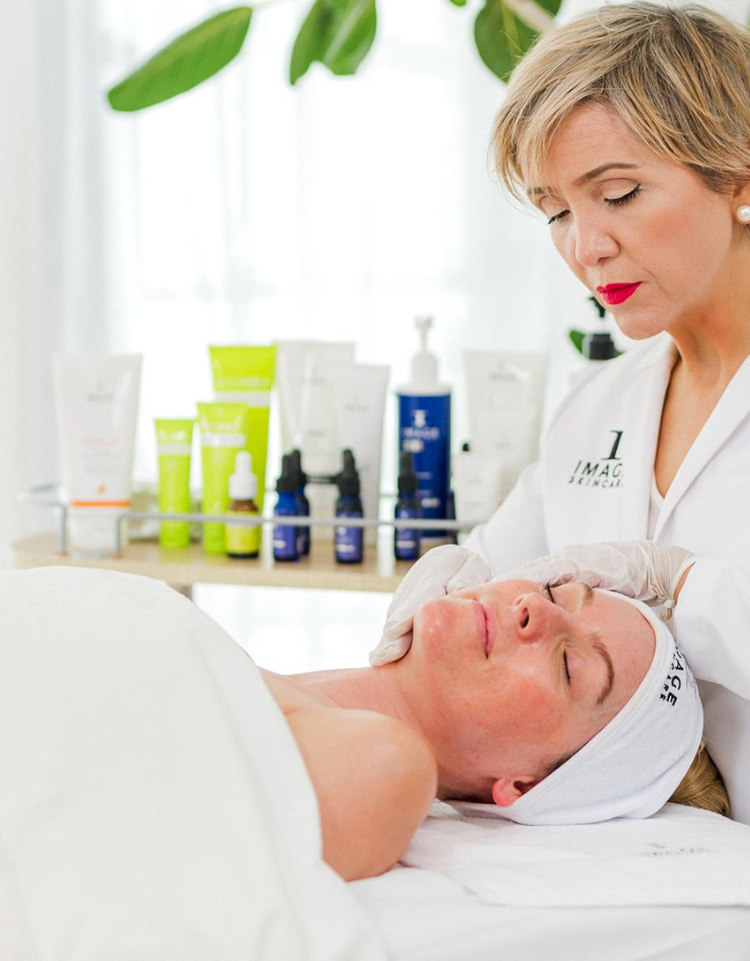women getting a facial treatment by Image Skincare esthetician