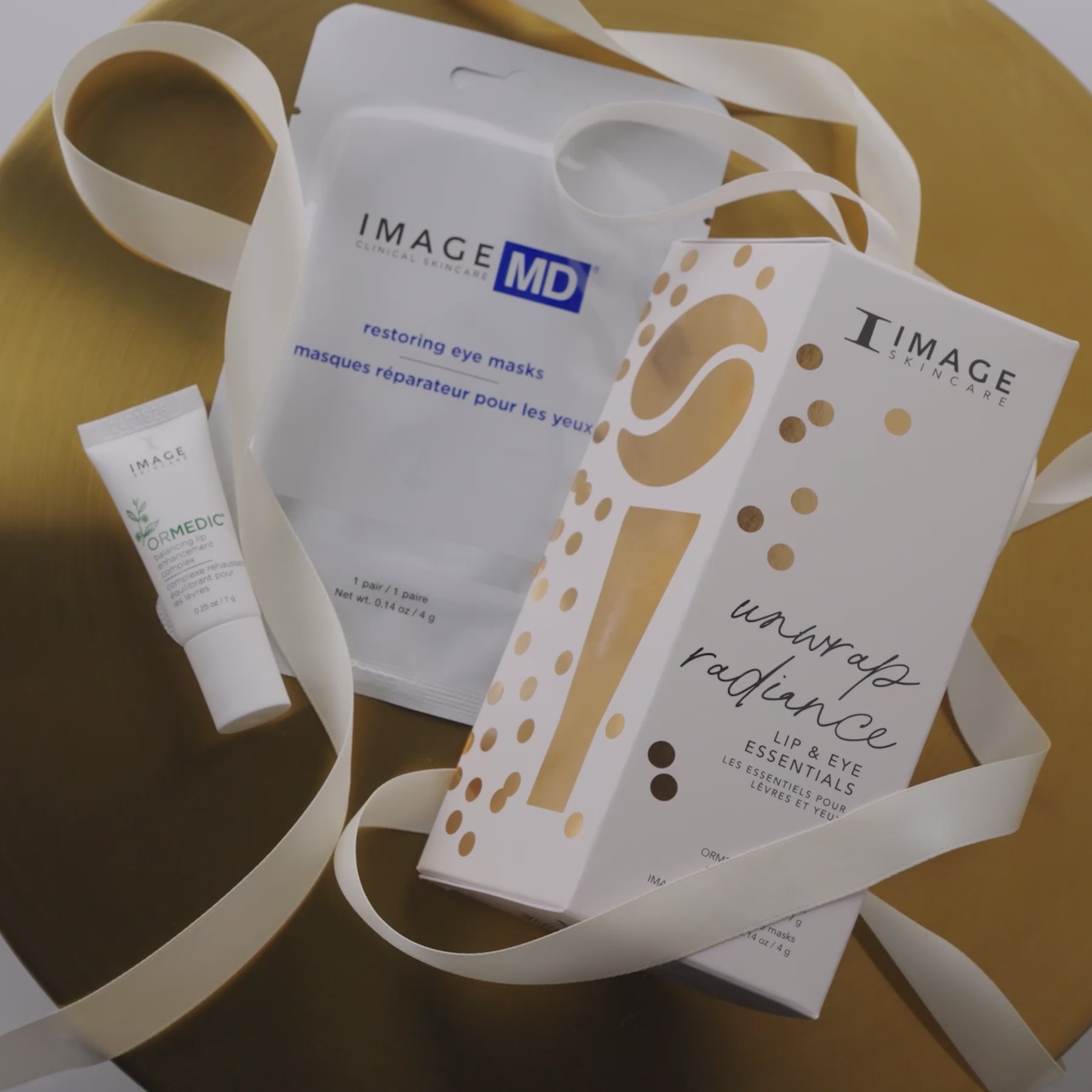 Video showing model grabbing unwrap radiance packaging and showcasing products on white displays