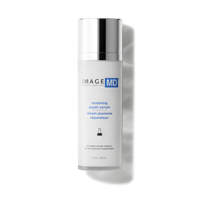 Skincare serum bottle labeled 'IMAGE MD restoring youth serum' on a white background