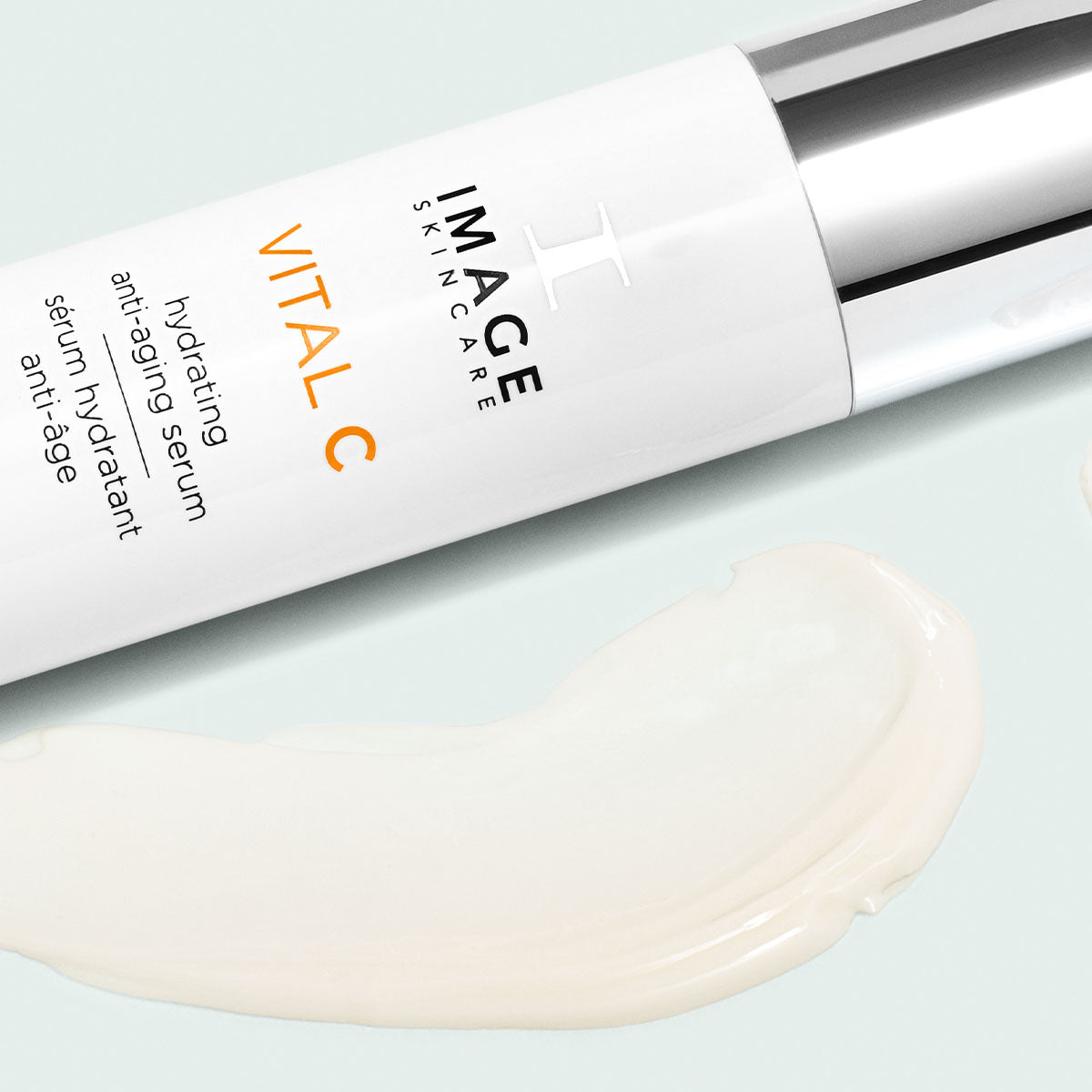 Side view of vitamin C serum alongside a smear of the anti aging hydrating serum.