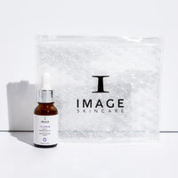 image brightening serum travel size bottle next to clear bubble bag