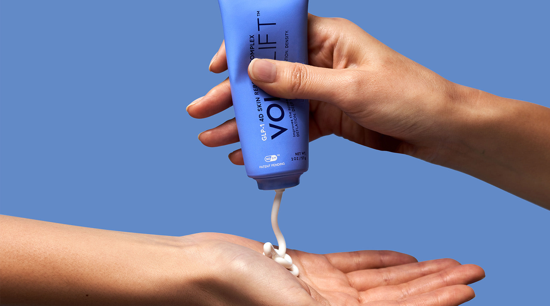 Hands squeezing skincare product of Vol.u.lift GLP-1 facial treatment