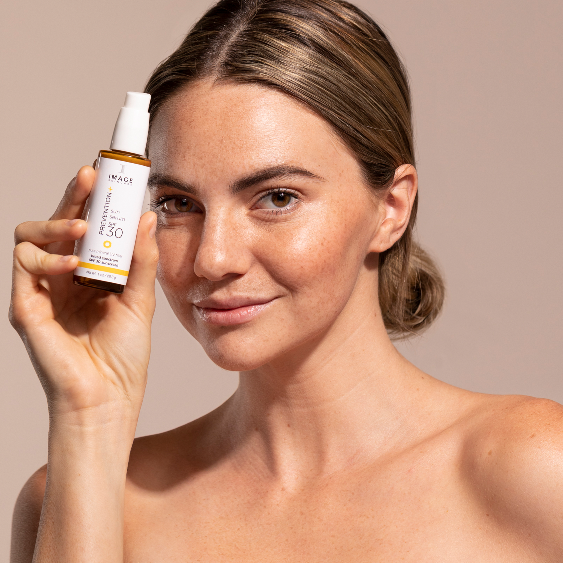 Women holding PREVENTION+ SPF 30 Sun Serum.