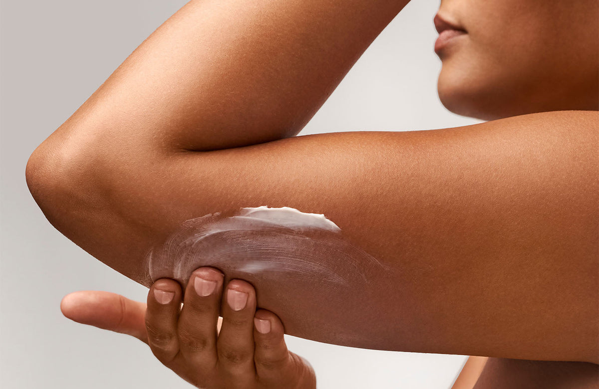 model applying creme to under arm