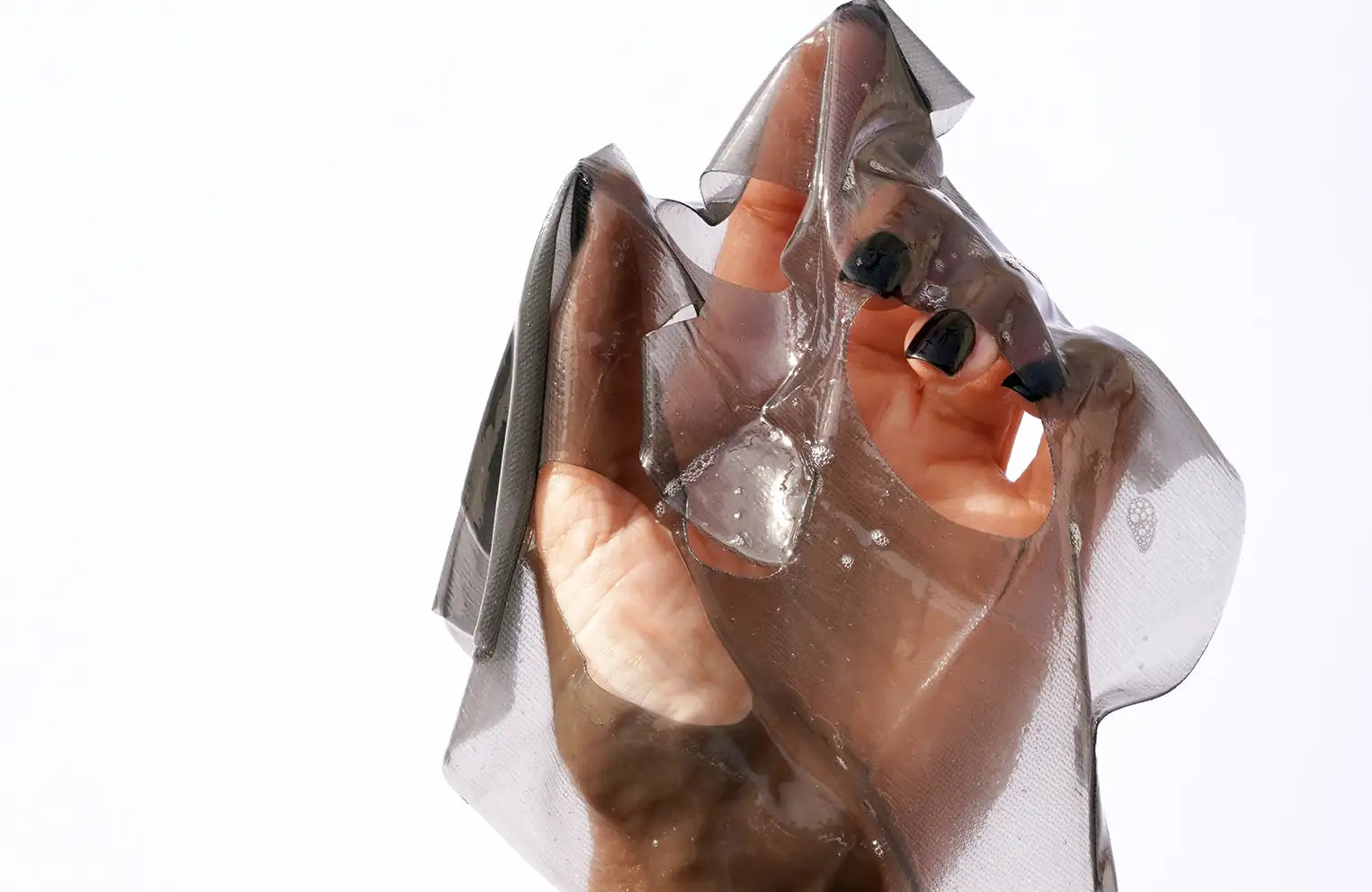 model hand holding sheet mask