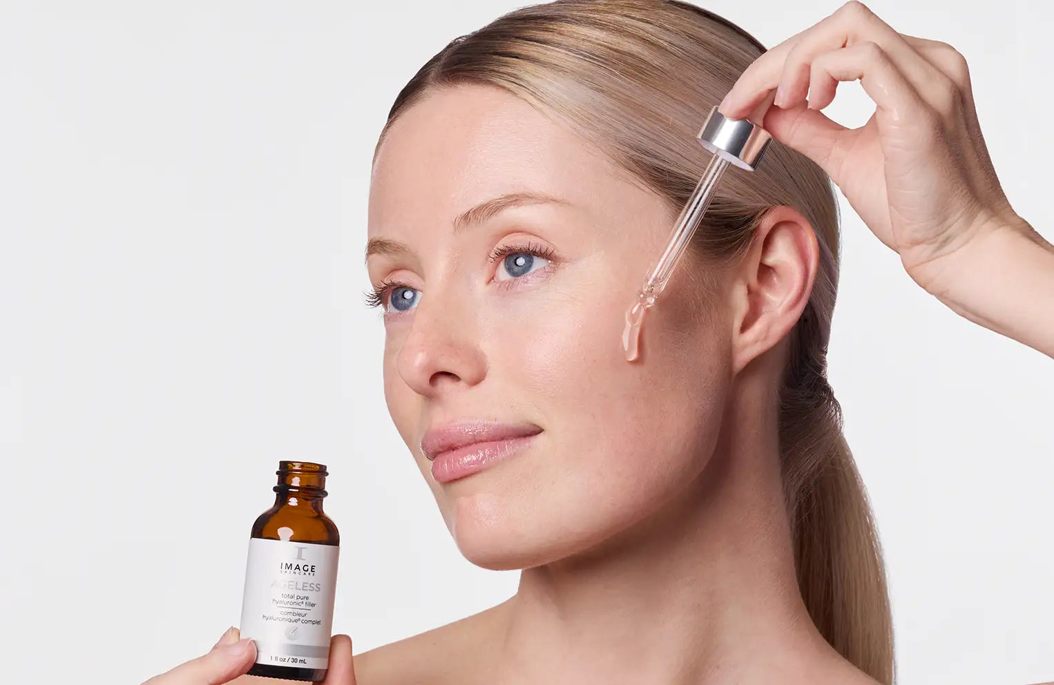 model applying holding bottle of ageless hyaluronic 6 filler and applying to face