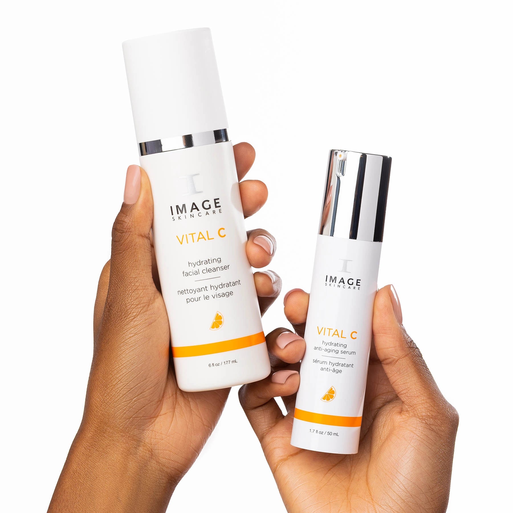 Two skincare bottles labeled 'IMAGE' held by a hand on a white background