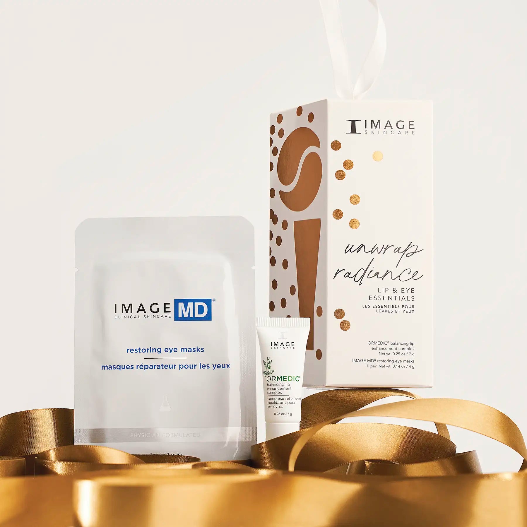 unwrap radiance kit and products on gold ribbons