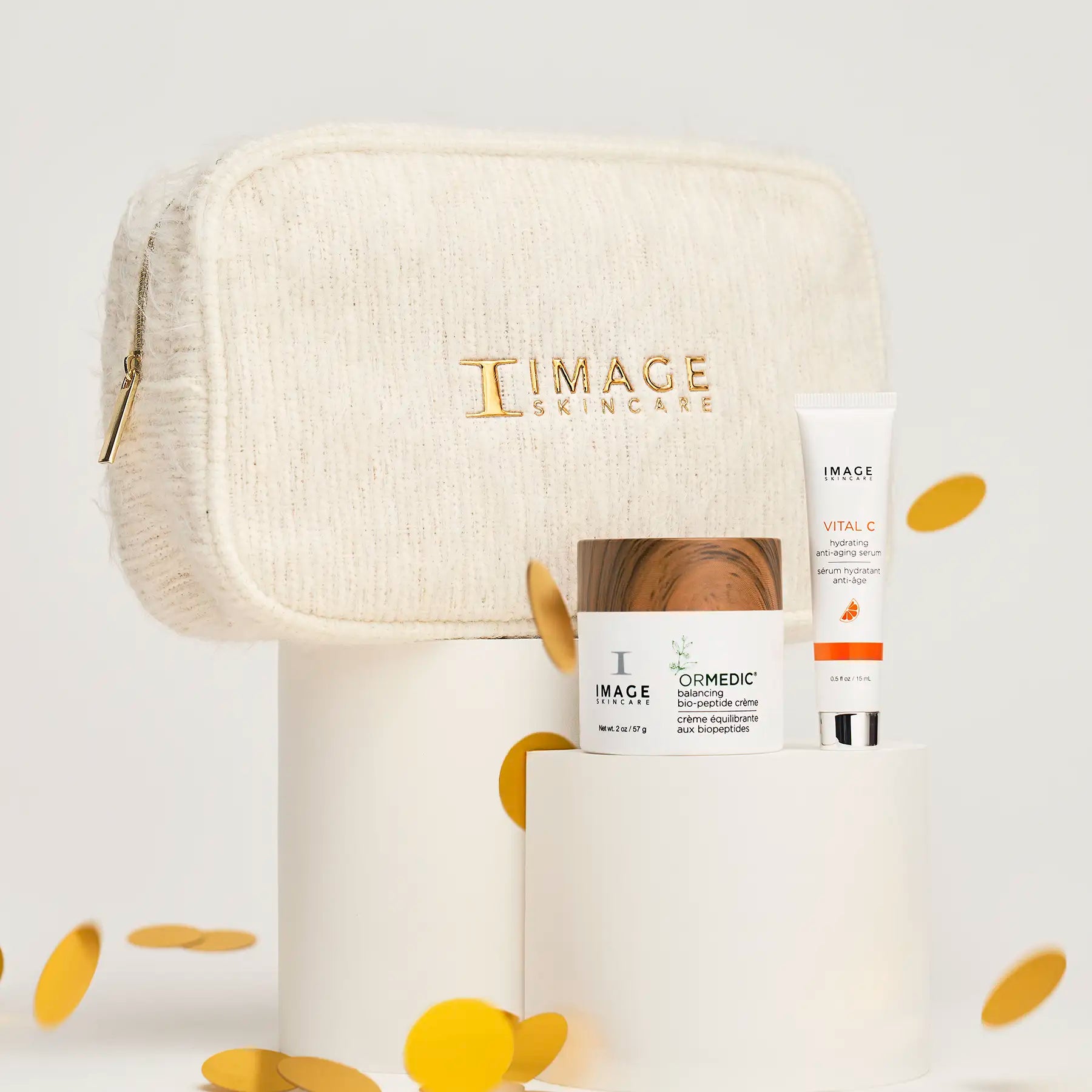 bag and 2 products on white stands with confetti