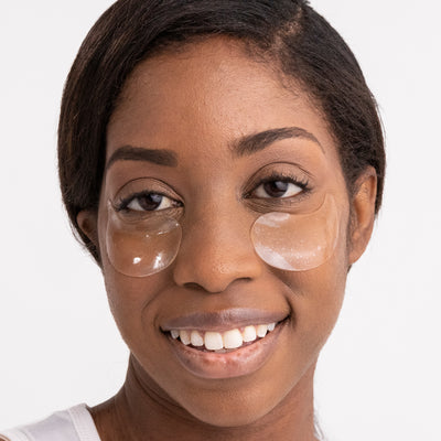 model face with eye masks applied under eyes