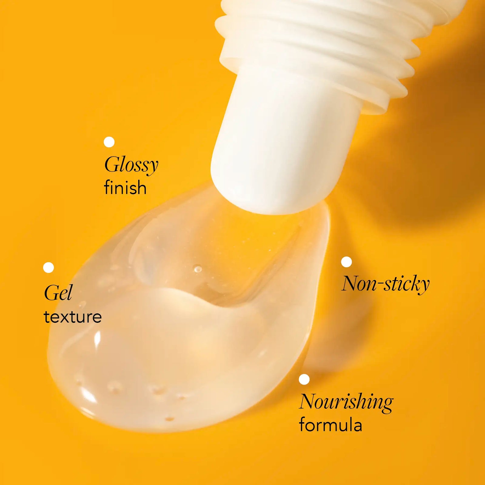Close-up of a dropper with gel texture on a yellow background, labeled as glossy finish, gel texture, non-sticky, and nourishing formula.