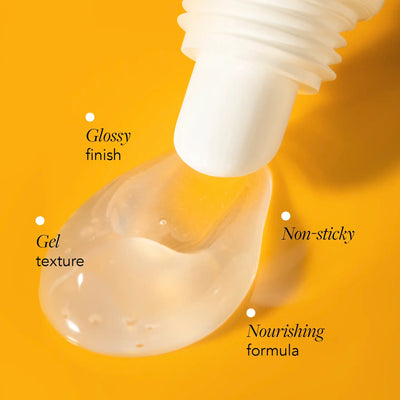 Close-up of a dropper with gel texture on a yellow background, labeled as glossy finish, gel texture, non-sticky, and nourishing formula.