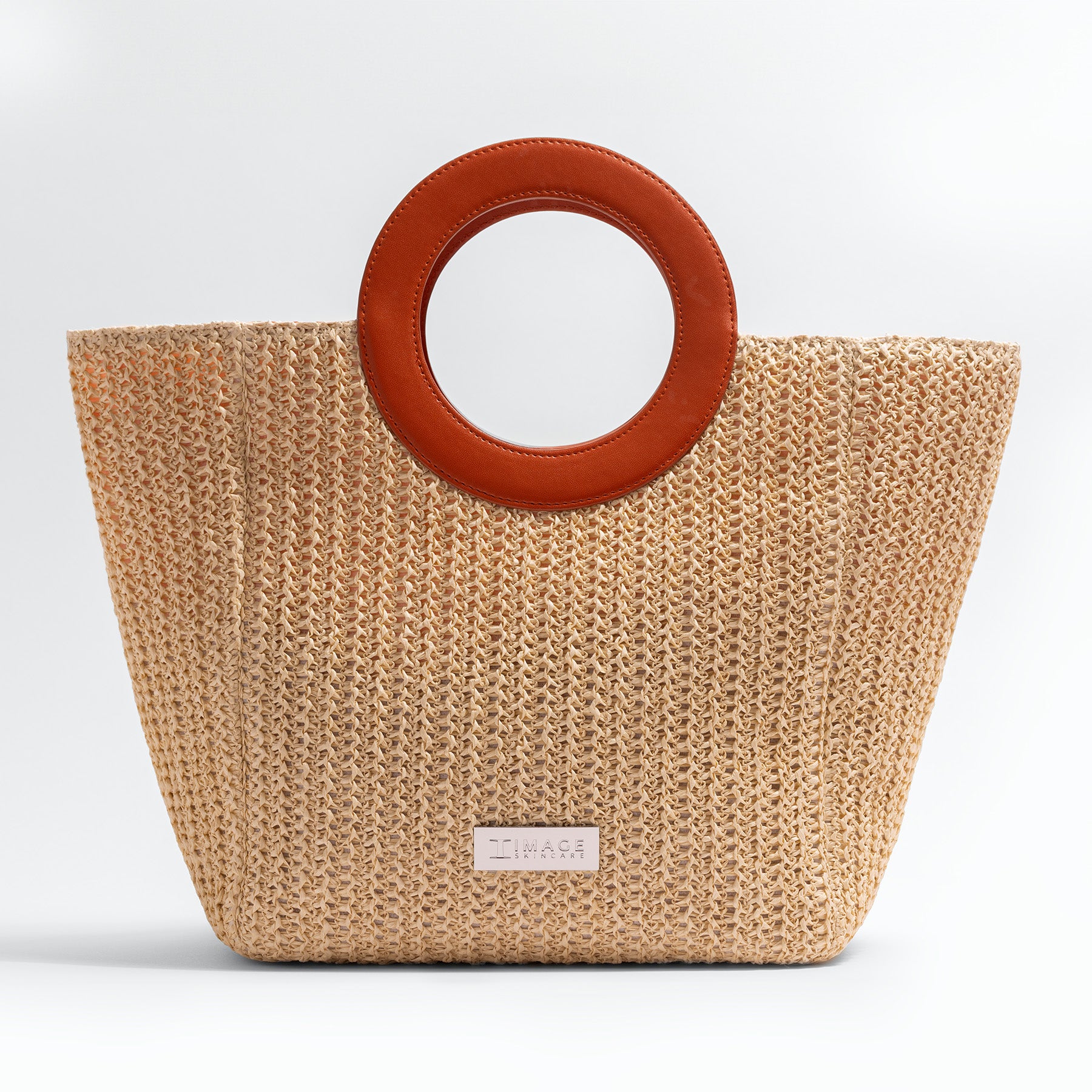 Beige woven handbag with brown circular handles on a white background