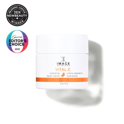 Image of a skincare cream jar with awards on a white background