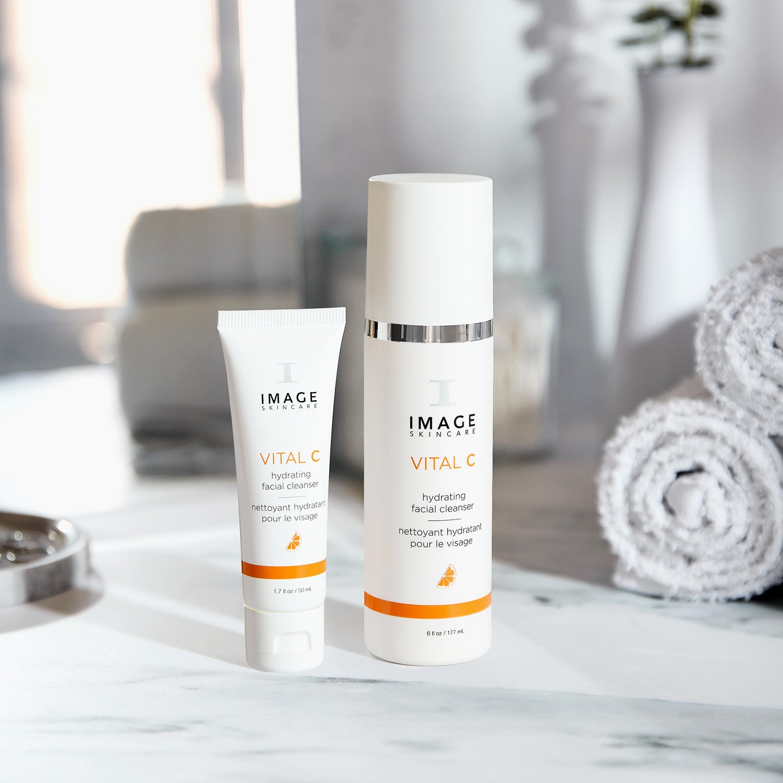 cleanser retail size next to travel size on bathroom counter