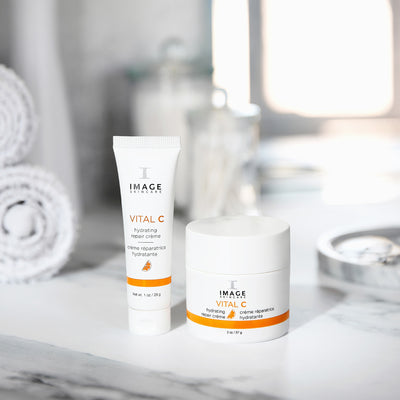 repair creme retail size next to travel size on bathroom counter