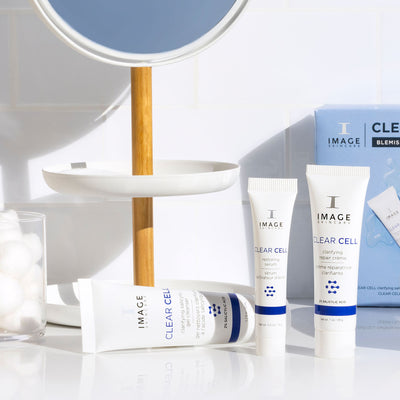 3 kit products on bathroom counter with product box in the back