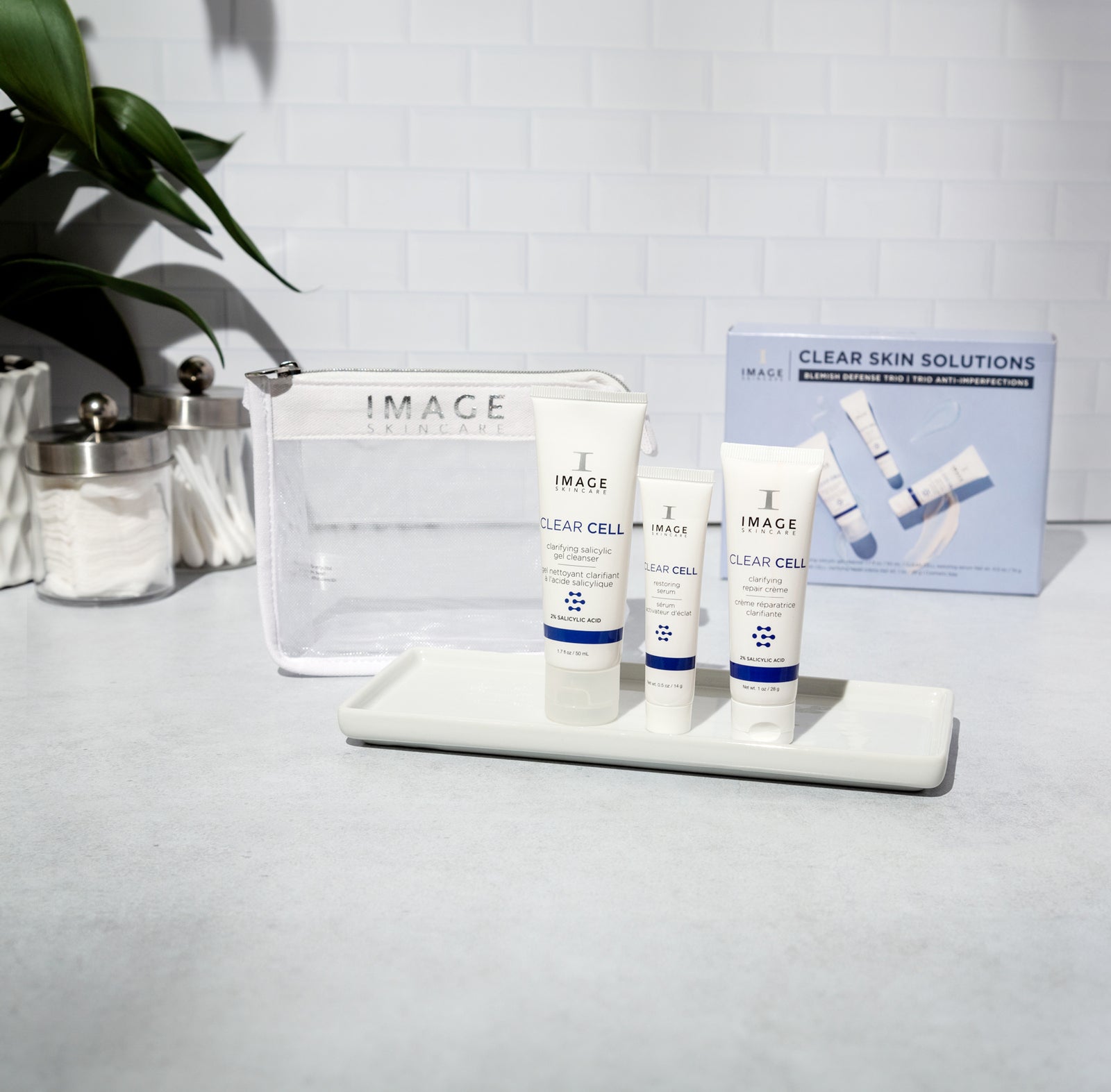 3 kit products on bathroom counter with white mesh bag and kit box behind products
