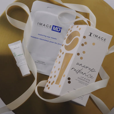Video showing model grabbing unwrap radiance packaging and showcasing products on white displays 