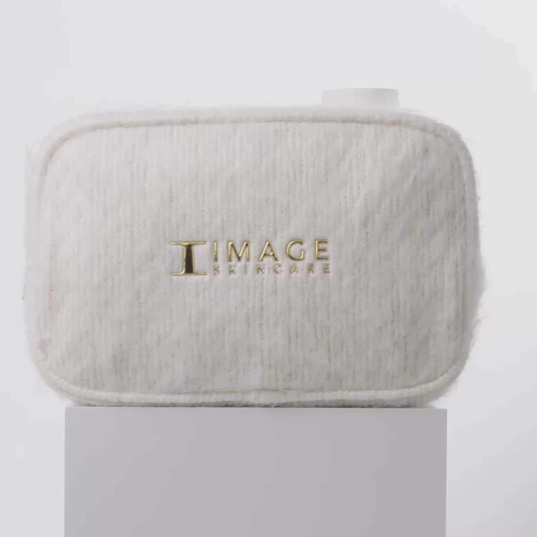 video of white bag and products spinning on block