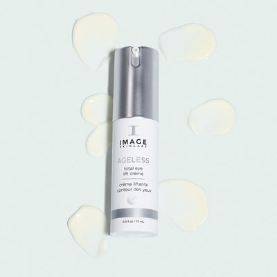 Ageless eye lift creme bottle on top of creme drops on light background