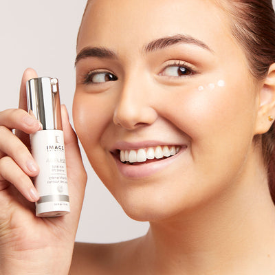 model holding product bottle near face