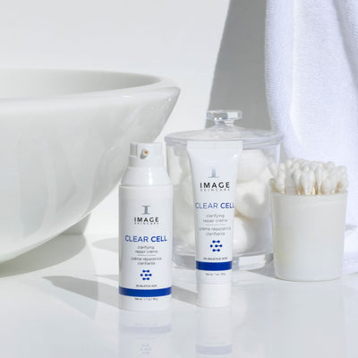 CLEAR CELL clarifying repair crème retail and travel size on bathroom counter
