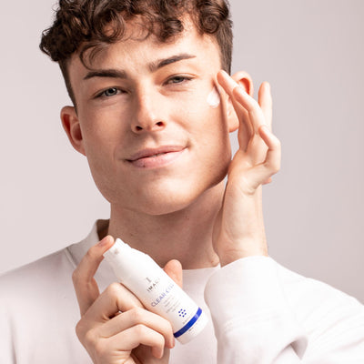 model applying CLEAR CELL clarifying repair crème to cheek