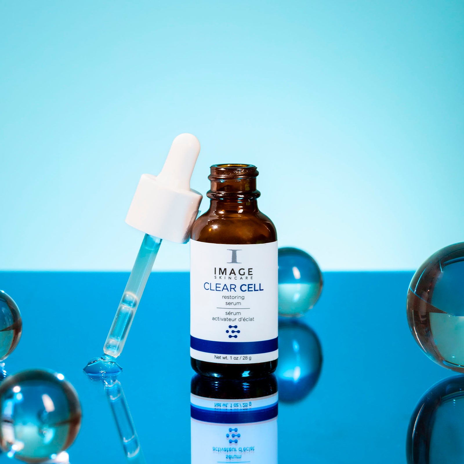 clear cell restoring serum open bottle on blue background