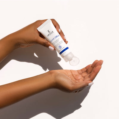 model hands holding product tube and dispensing product on palm