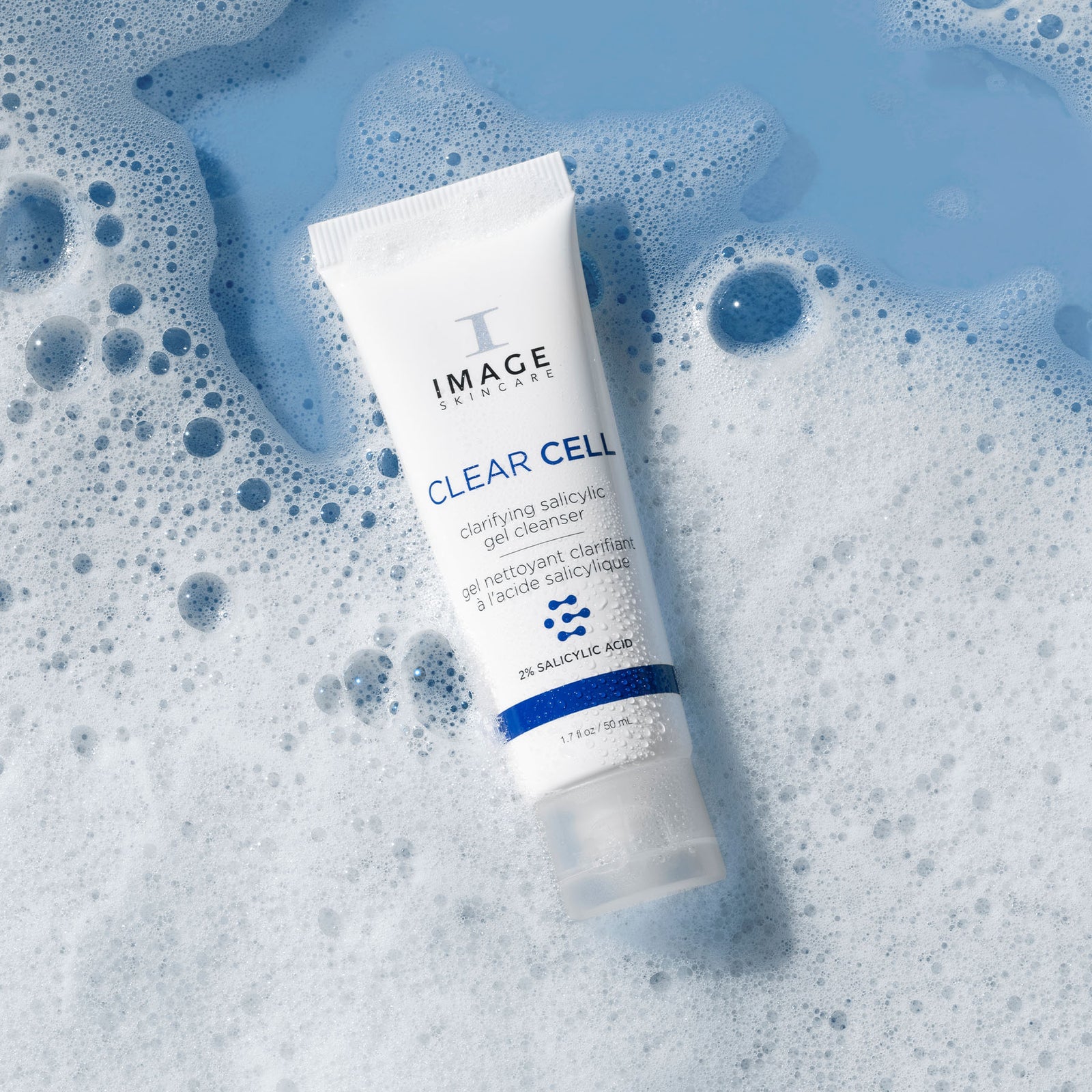cleanser tube on blue background surrounded by cleanser bubbles