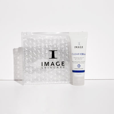 clear cell cleanser travel size tube next to clear bubble bag