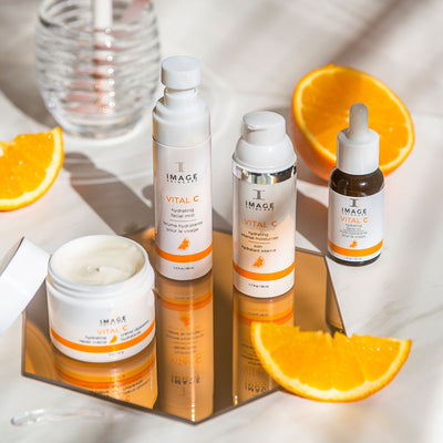 VITAL C retail collection products on a countertop background with orange slices