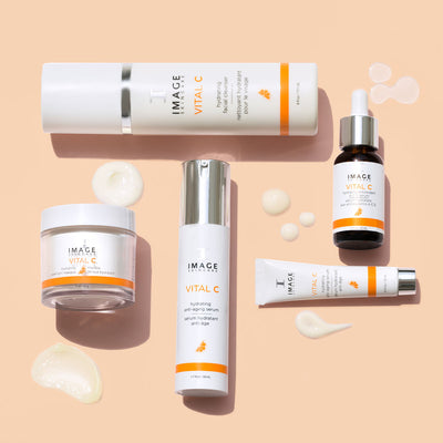 collection shot of VITAL C products on an orange background with texture drops next to each product