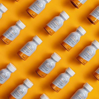 multiple yana bottles on orange background