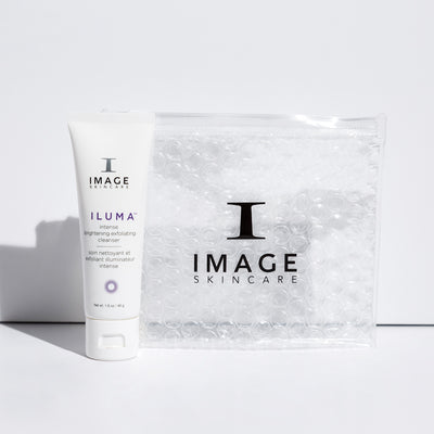 tube of travel size ILUMA cleanser next to white bubble bag 